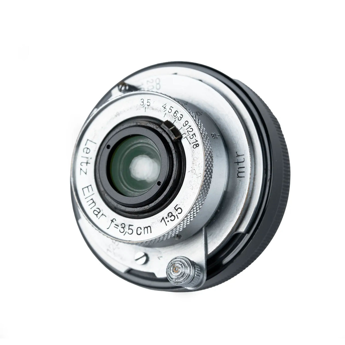 A vintage LEica Elmar 35mm f/3.5 camera lens adapter with a silver-toned metal front ring and a black ribbed rear mount, shown on a white background.